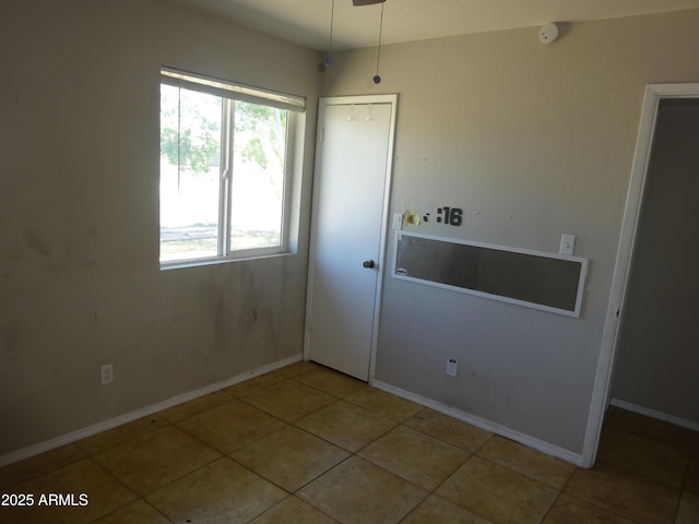 3171 W Orchid Ln, Phoenix, AZ 85051 - spare room featuring tile patterned floors and baseboards