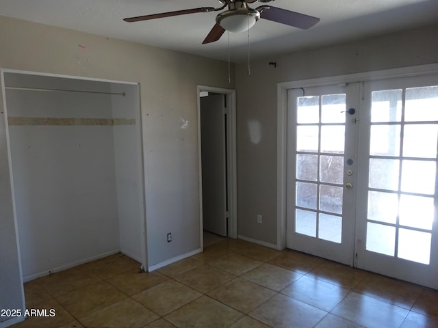3171 W Orchid Ln, Phoenix, AZ 85051 - unfurnished bedroom with french doors, tile patterned floors, baseboards, and a ceiling fan