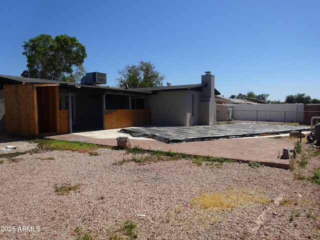 3171 W Orchid Ln, Phoenix, AZ 85051 - rear view of property with a patio area, fence, central air condition unit, and a chimney
