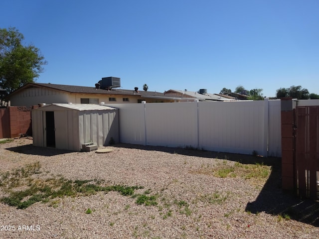 3171 W Orchid Ln, Phoenix, AZ 85051 - rear view of house with a shed, a fenced backyard, and an outbuilding