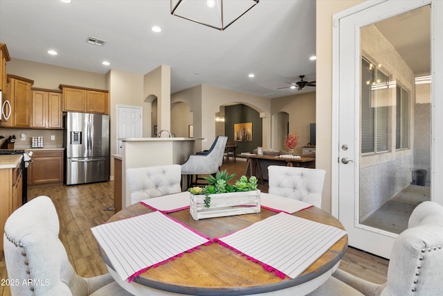 dining area featuring ceiling fan and light wood-type flooring