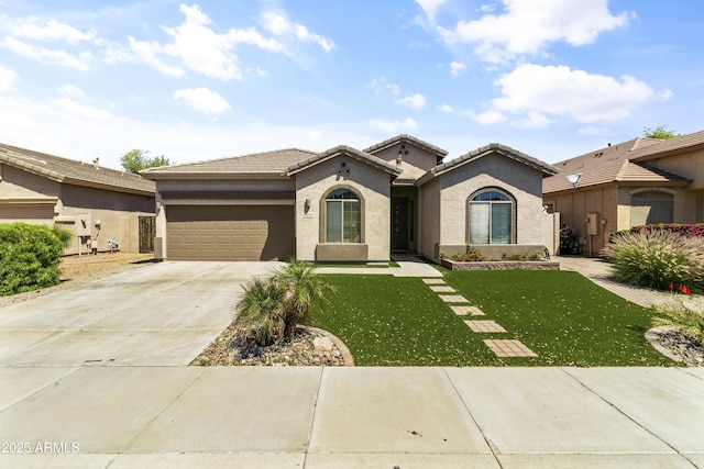 view of front of home with a front yard and a garage