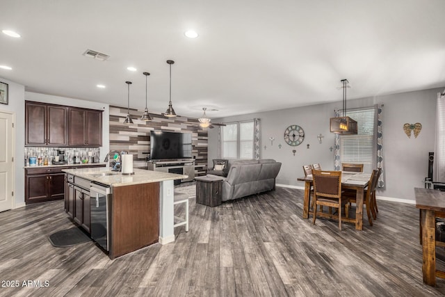 291 N Scott Dr, Chandler, AZ 85225 - kitchen featuring a breakfast bar, a sink, dark wood-style floors, a kitchen island with sink, and dark brown cabinets