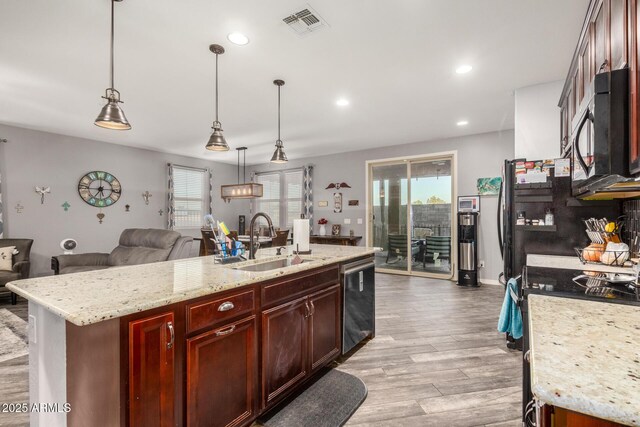 291 N Scott Dr, Chandler, AZ 85225 - kitchen with a sink, black microwave, light wood-style floors, open floor plan, and stainless steel dishwasher