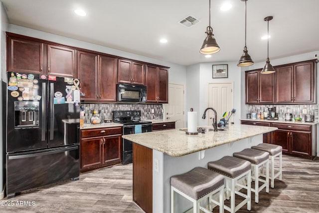 291 N Scott Dr, Chandler, AZ 85225 - kitchen featuring backsplash, a sink, visible vents, black appliances, and wood finished floors