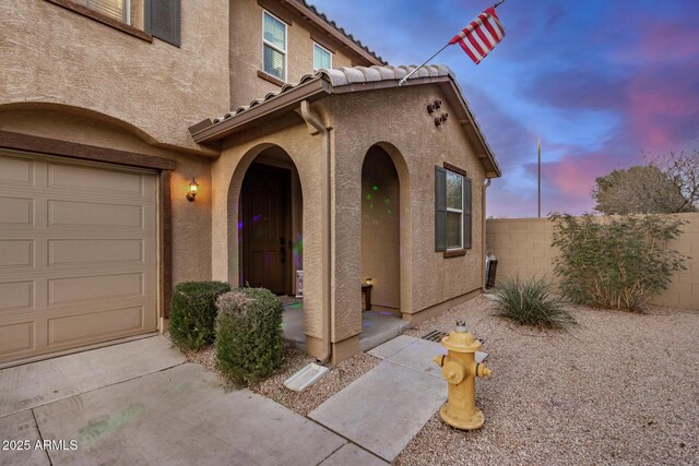 291 N Scott Dr, Chandler, AZ 85225 - entrance to property with stucco siding, a garage, a tiled roof, and fence