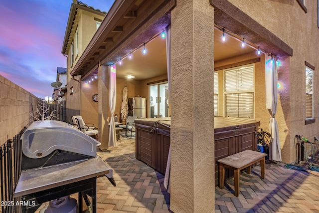 291 N Scott Dr, Chandler, AZ 85225 - patio terrace at dusk with a hot tub and a fenced backyard
