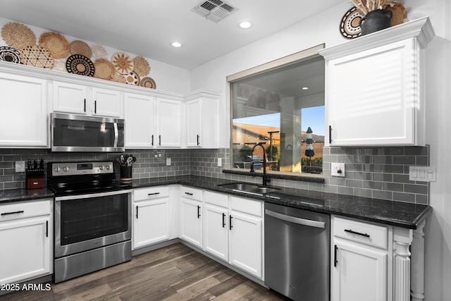 kitchen with visible vents, a sink, white cabinetry, and stainless steel appliances