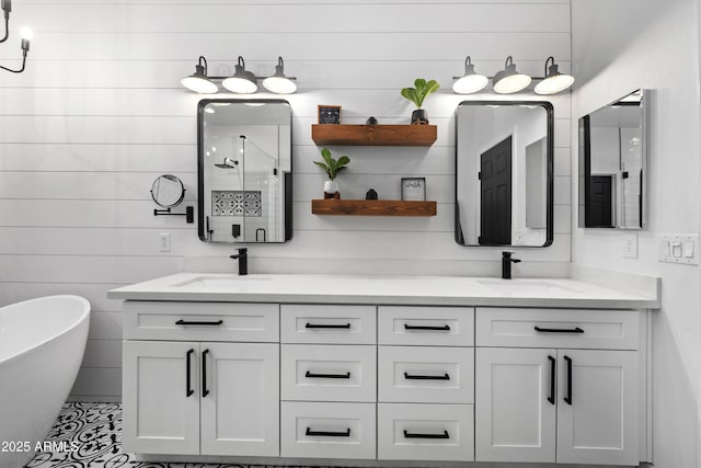 full bathroom featuring a sink, a soaking tub, a shower stall, and double vanity