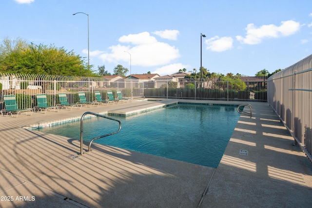 community pool featuring a patio and fence