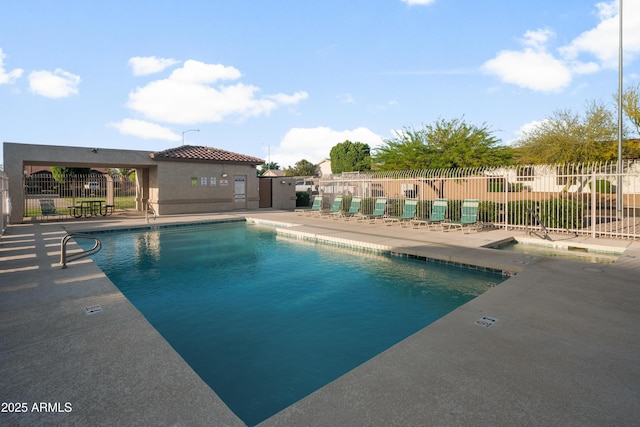 pool featuring a patio and fence