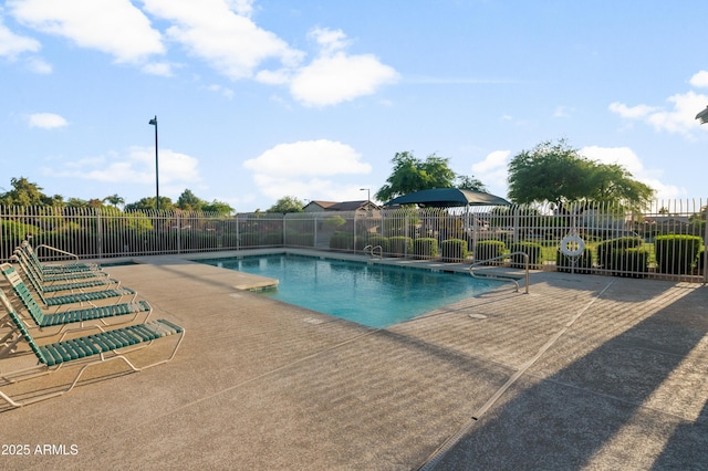 pool featuring a patio area and fence