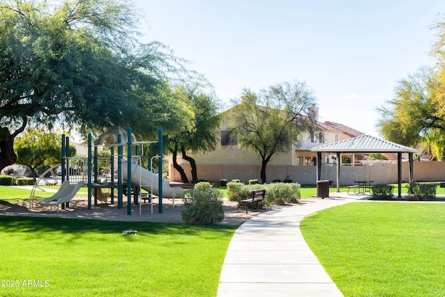 view of community featuring a gazebo, a lawn, fence, and playground community