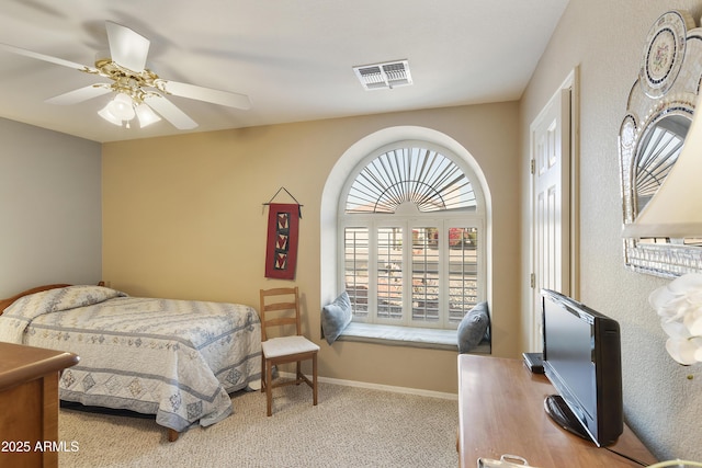 bedroom featuring light carpet and ceiling fan