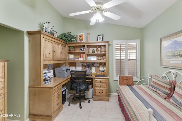 home office featuring ceiling fan, light tile patterned floors, and vaulted ceiling