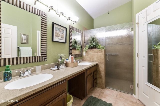 bathroom featuring tile patterned floors, a shower with door, vanity, and vaulted ceiling