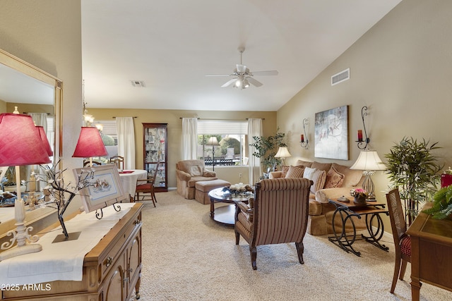 living room featuring light carpet, ceiling fan, and vaulted ceiling