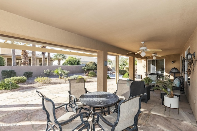 view of patio featuring ceiling fan