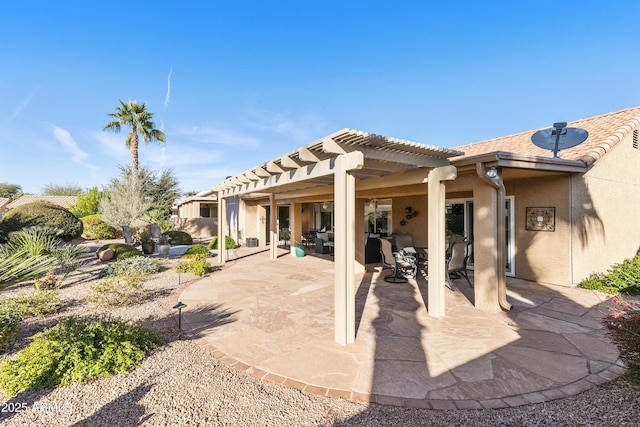 back of house with a pergola and a patio