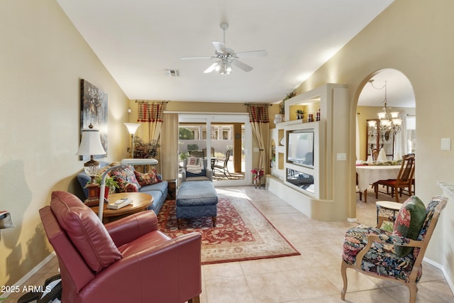 tiled living room featuring ceiling fan with notable chandelier