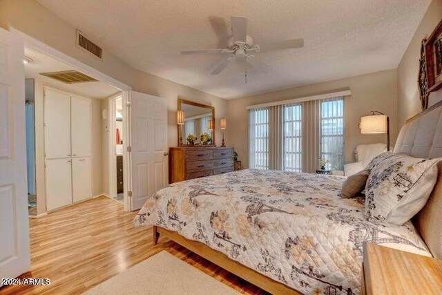 bedroom featuring a textured ceiling, ceiling fan, and wood-type flooring