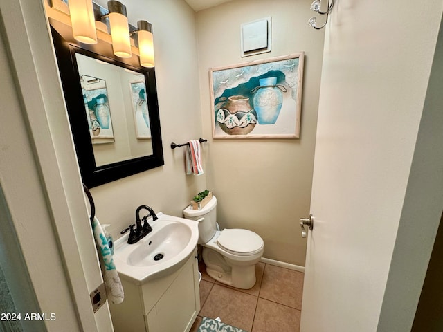 bathroom with vanity, tile patterned flooring, and toilet