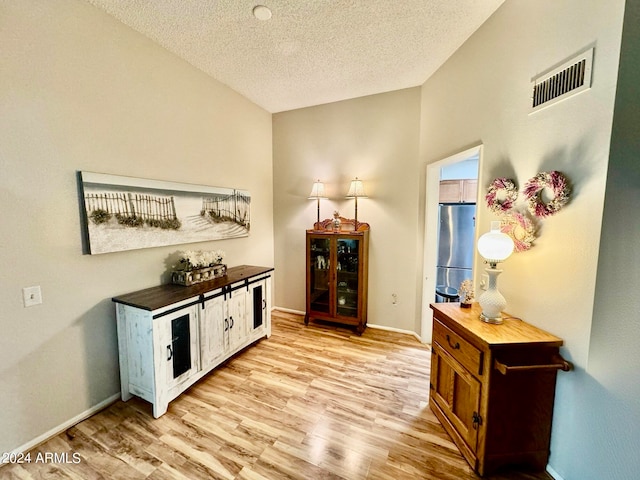 interior space featuring light hardwood / wood-style floors and a textured ceiling