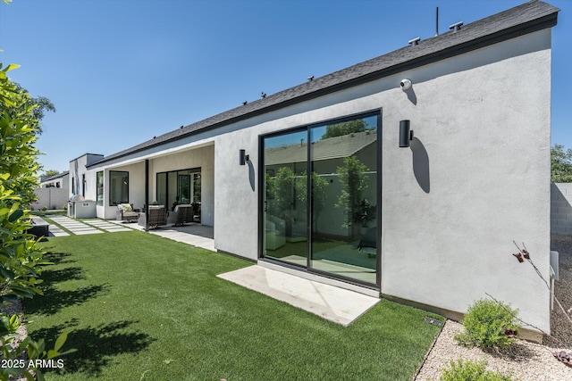 6329 N 10th Dr, Phoenix, AZ 85013 - rear view of house featuring a yard, stucco siding, an outdoor living space, and a patio area