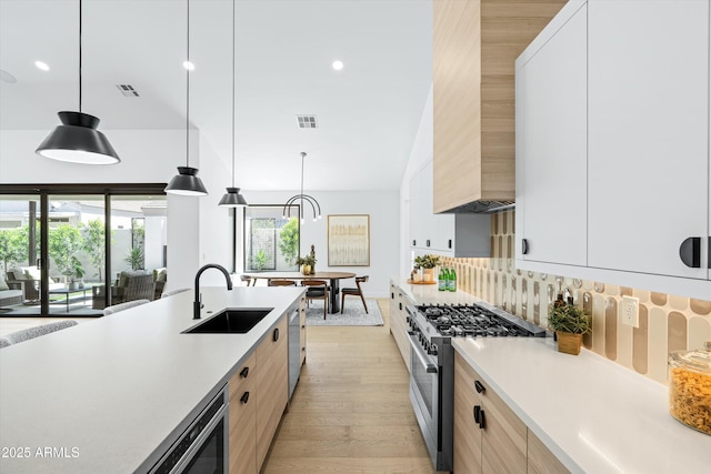 6329 N 10th Dr, Phoenix, AZ 85013 - kitchen featuring modern cabinets, visible vents, light countertops, and appliances with stainless steel finishes