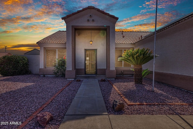 view of exterior entry at dusk