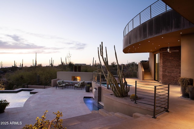 patio terrace at dusk with pool water feature and ceiling fan