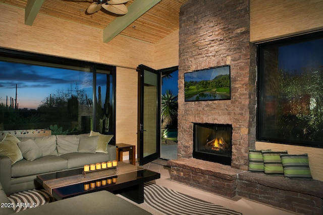 patio terrace at dusk featuring an outdoor living space with a fireplace and ceiling fan