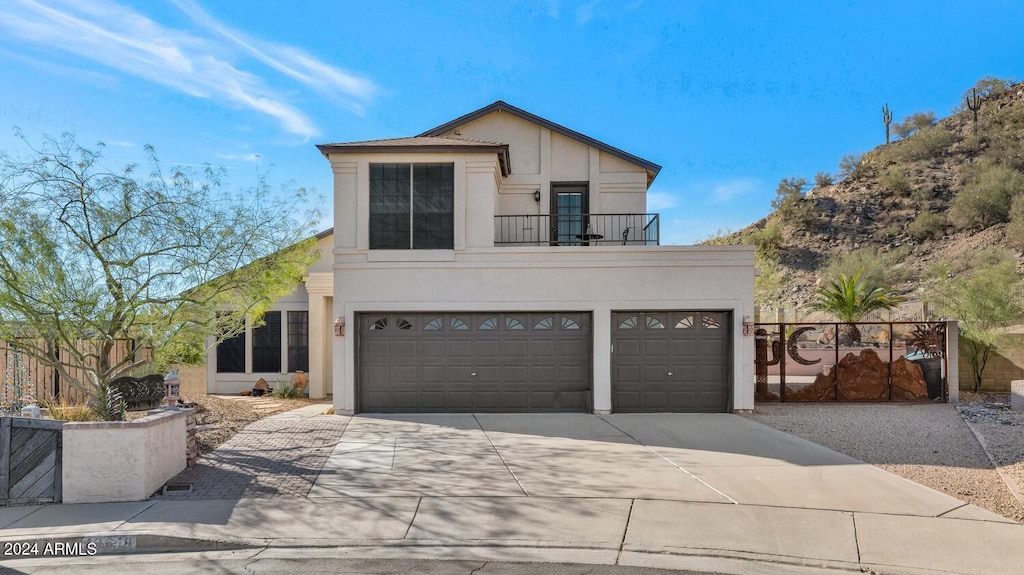 view of front of home with a balcony and a garage