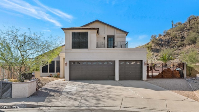 view of front of home with a balcony and a garage