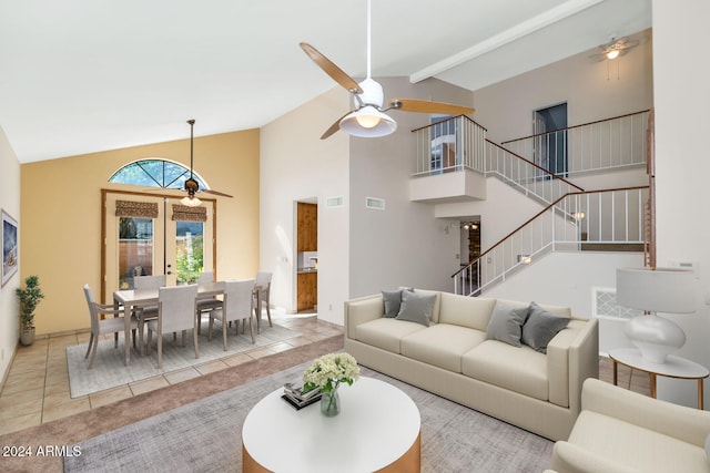 tiled living room with beam ceiling, high vaulted ceiling, french doors, and ceiling fan