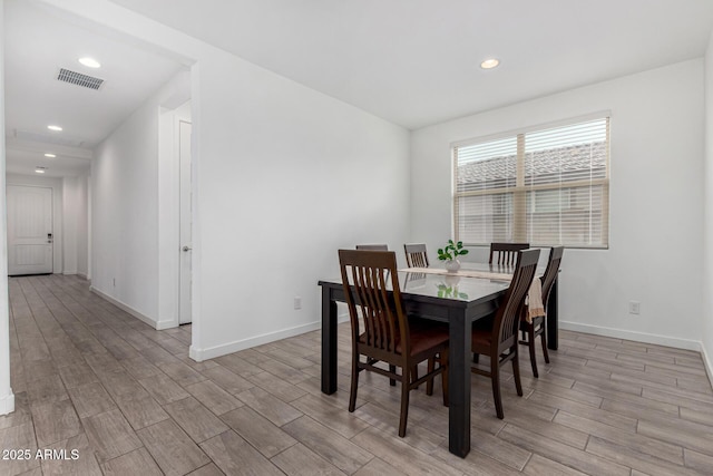 dining room featuring recessed lighting, baseboards, visible vents, and light wood finished floors