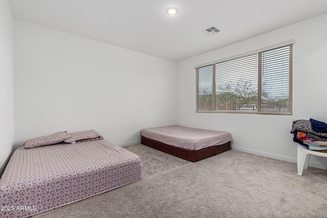 bedroom featuring carpet flooring, visible vents, and baseboards