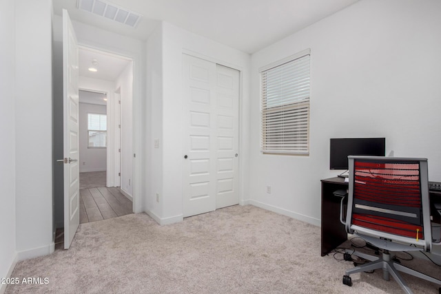 office area featuring carpet floors, baseboards, and visible vents