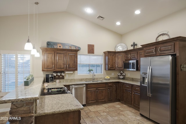 kitchen featuring stainless steel appliances, a sink, a peninsula, high vaulted ceiling, and hanging light fixtures
