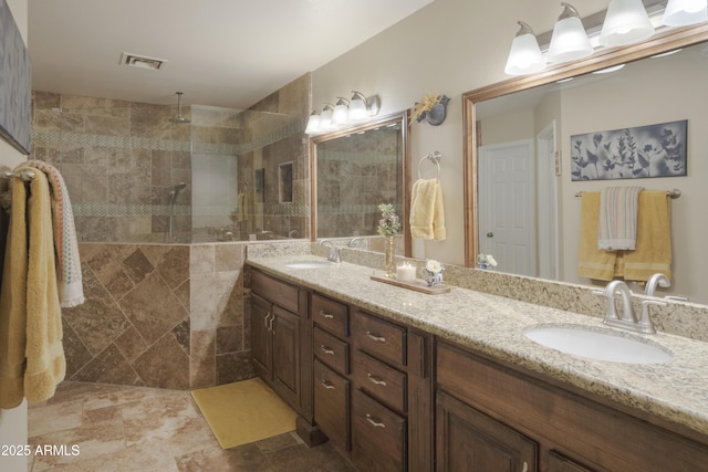 full bathroom with double vanity and a walk in shower