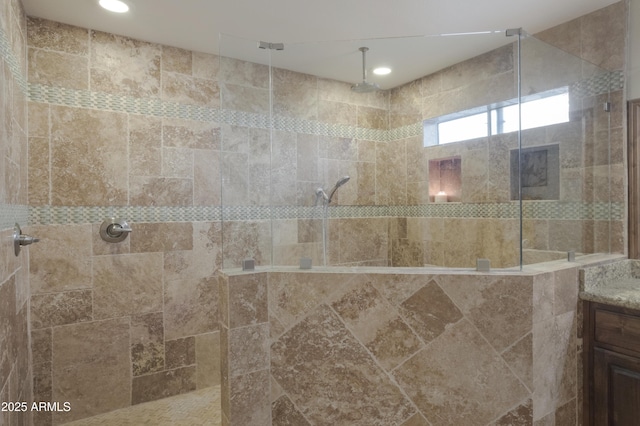 full bath featuring walk in shower and vanity