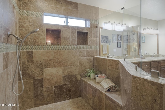 full bath featuring a walk in shower and vanity