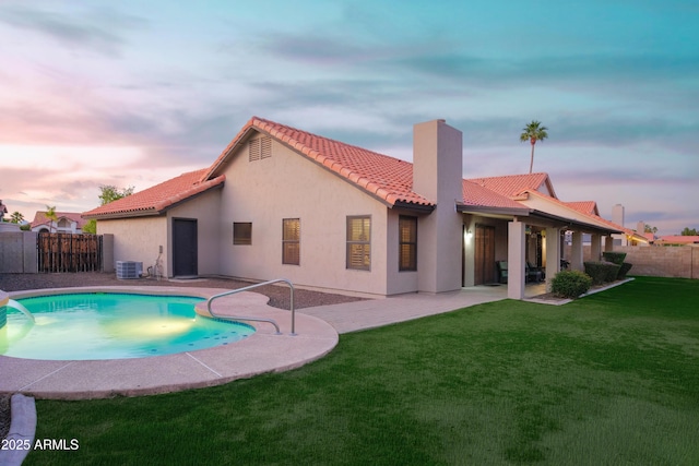 pool at dusk with central AC unit and a patio area