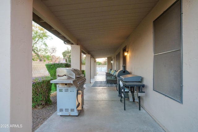 view of patio with a grill and fence