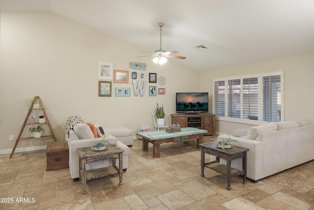 living area with lofted ceiling, stone tile floors, a ceiling fan, and baseboards