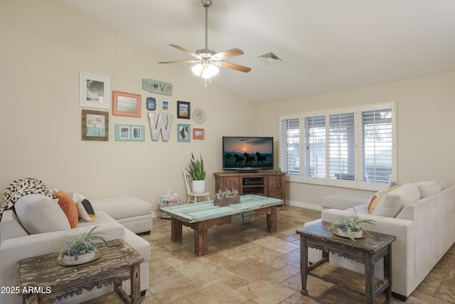 living room with vaulted ceiling, ceiling fan, stone tile flooring, and baseboards