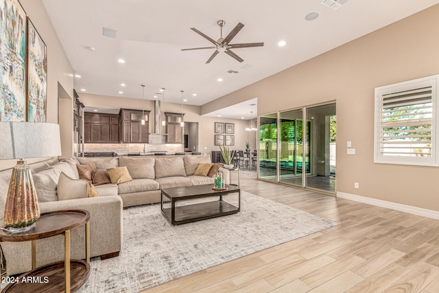 living room with ceiling fan and light hardwood / wood-style floors