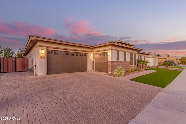 prairie-style house featuring a lawn and a garage