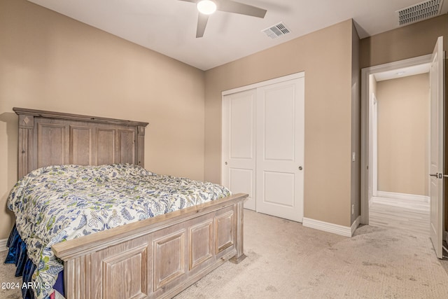 carpeted bedroom featuring a closet and ceiling fan