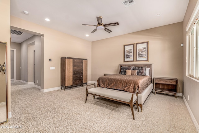 bedroom featuring multiple windows, ceiling fan, and light carpet